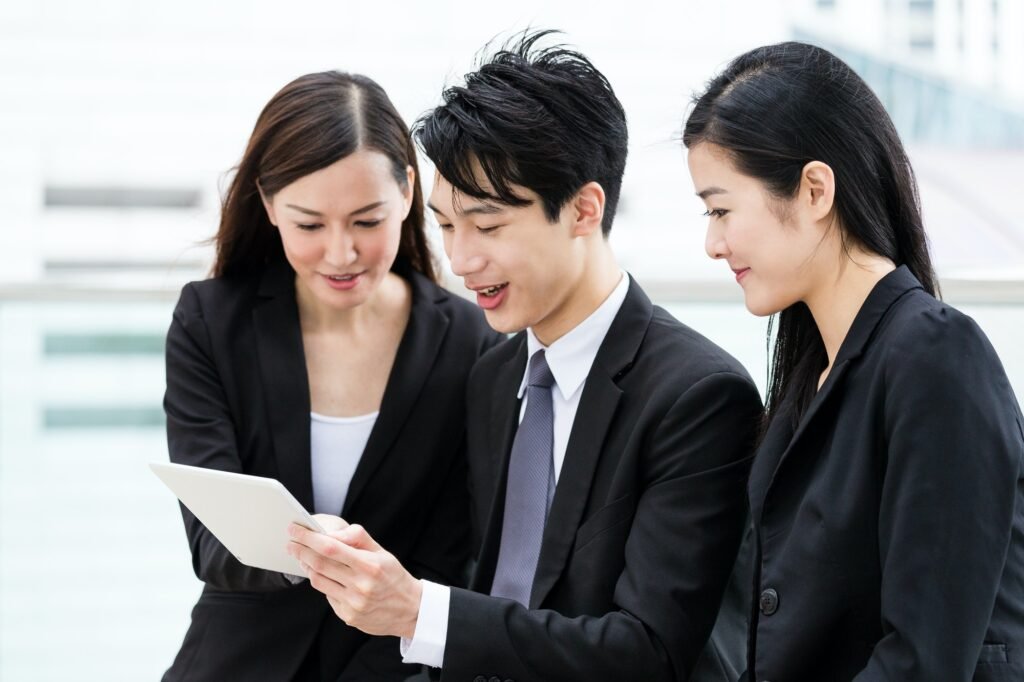 Asian business people read on digital tablet