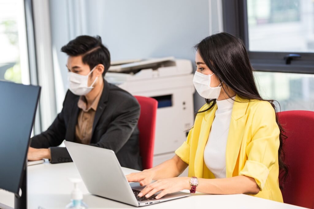 Asian employee working working at office desk