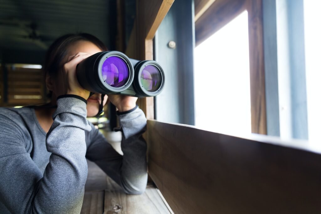 Asian woman use of the telescope at indoor