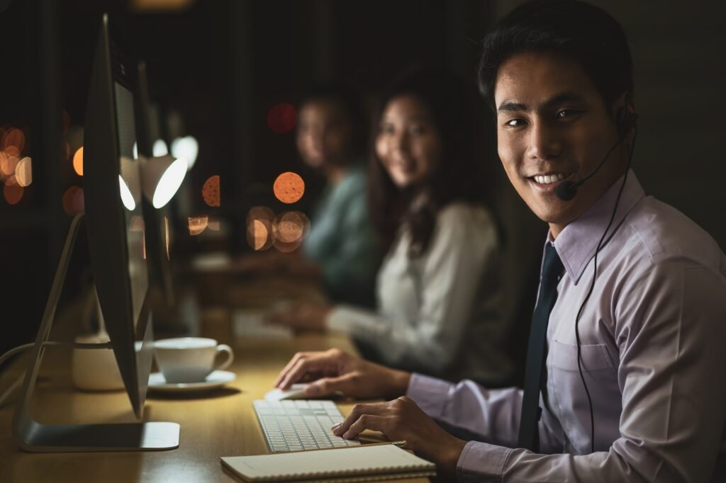 Portrait of Asian Male customer care service with businesswoman smiling and working hard